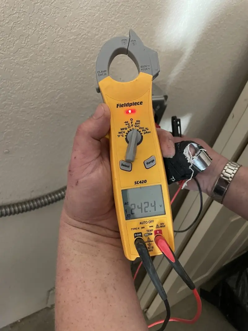 Voltage testing with clamp meter during Recessed Lighting Installation in Le Roy